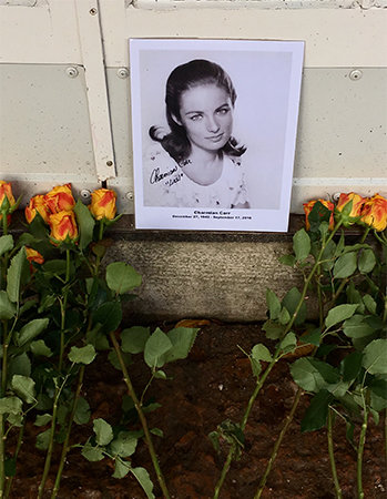 The year Charmian passed Angela's Craftour group lays flowers outside the gazebo.